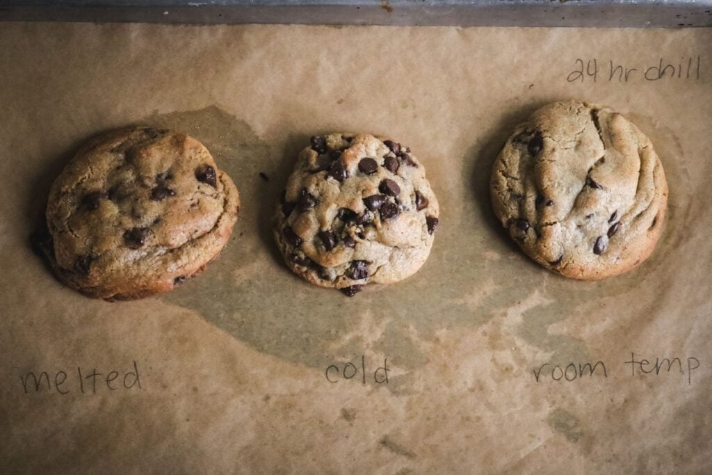 overhead view of three brown butter chocolate chip cookies with labels to show the different recipes tested for this recipe development.