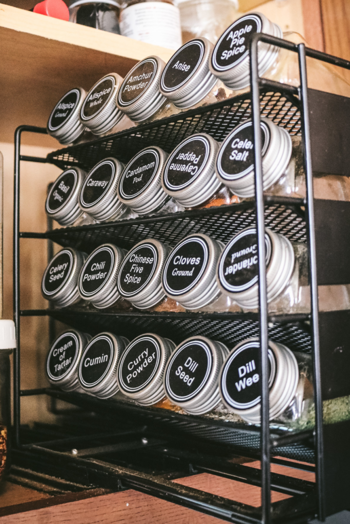 slide out spice rack pull of jars of spices.
