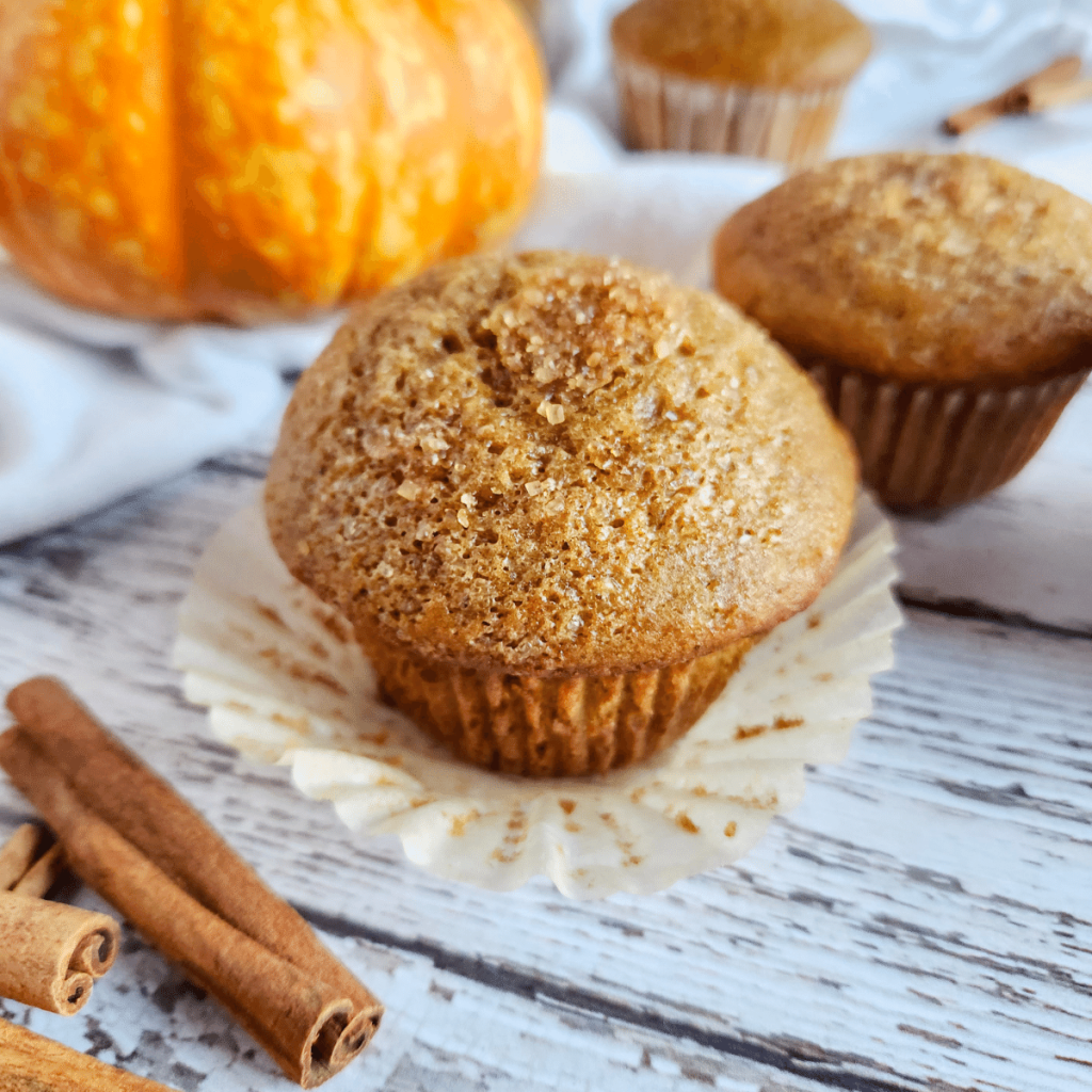 pumpkin spice muffins with sourdough on a wooden surface.