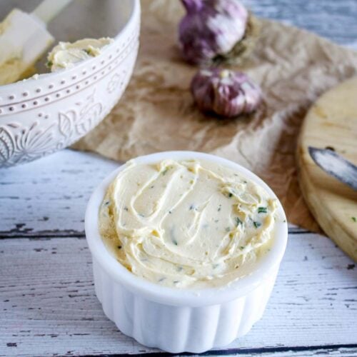 white jar filled with homemade roasted garlic her butter.