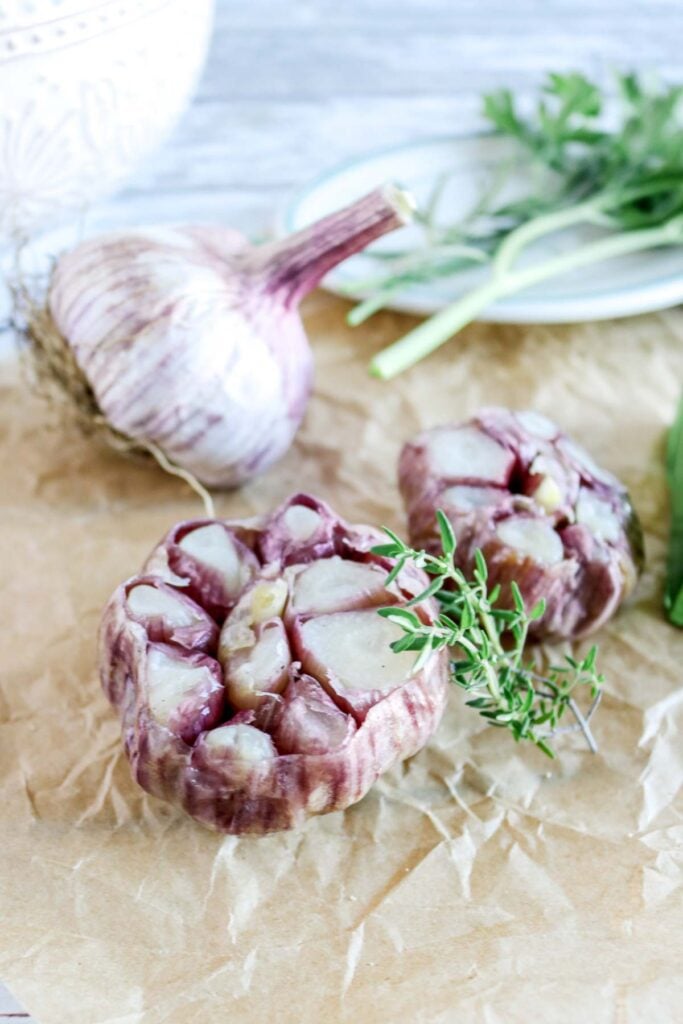 freshly roasted garlic next to fresh thyme.