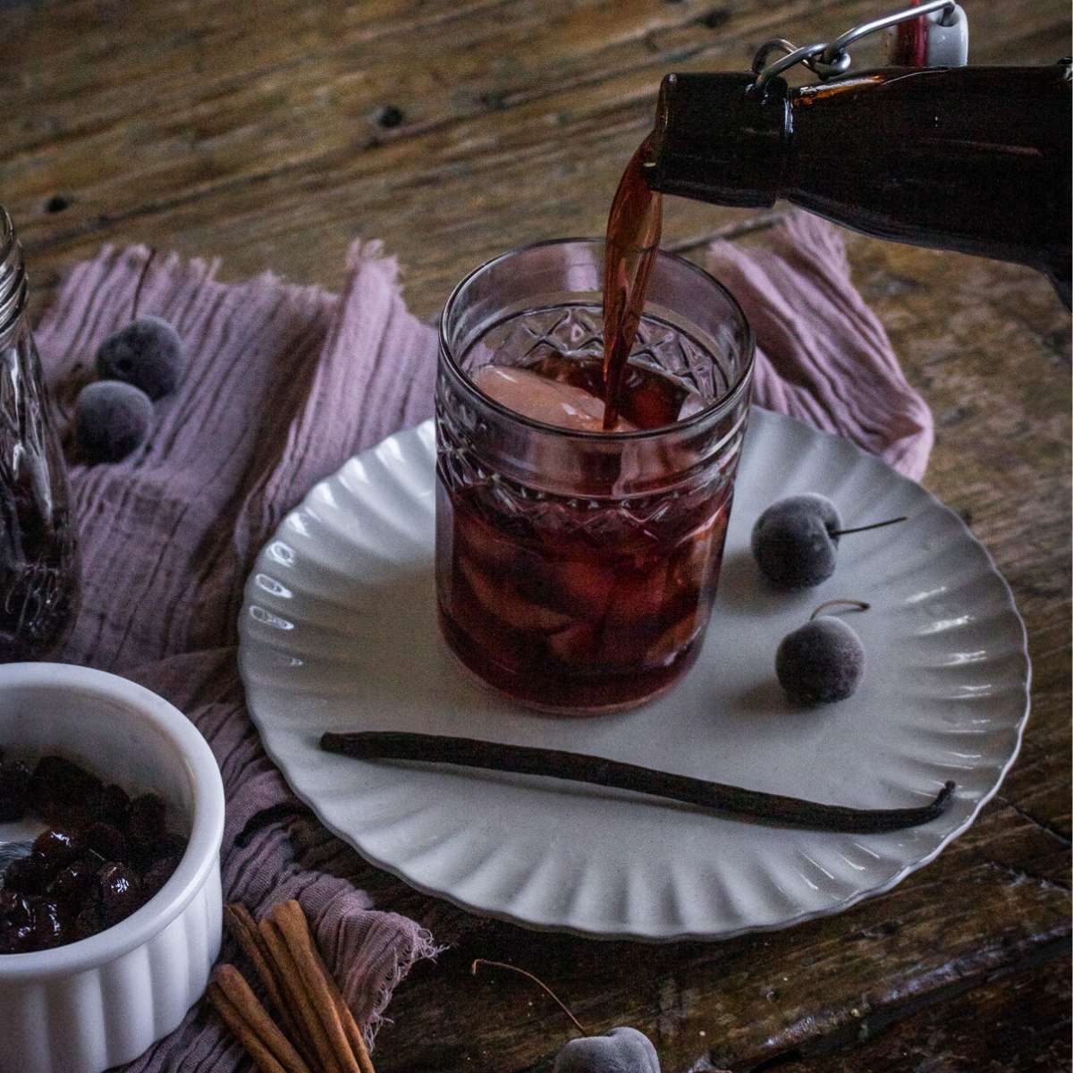 cocktail glass with cherry infused bourbon.