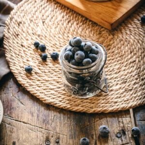 vintage mason jar with frozen blueberries.