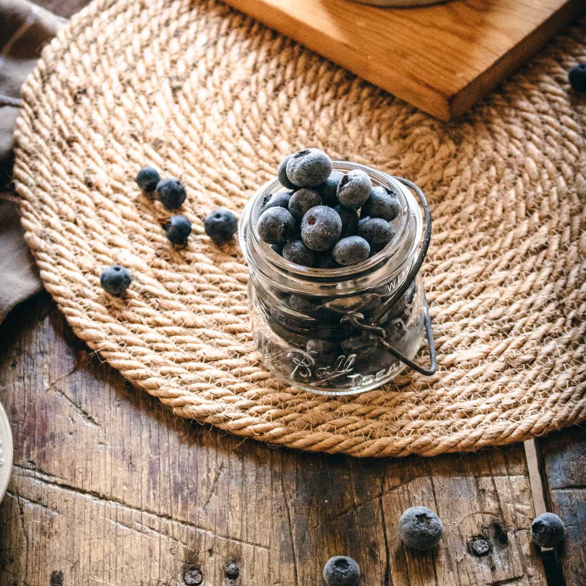 vintage mason jar with frozen blueberries.