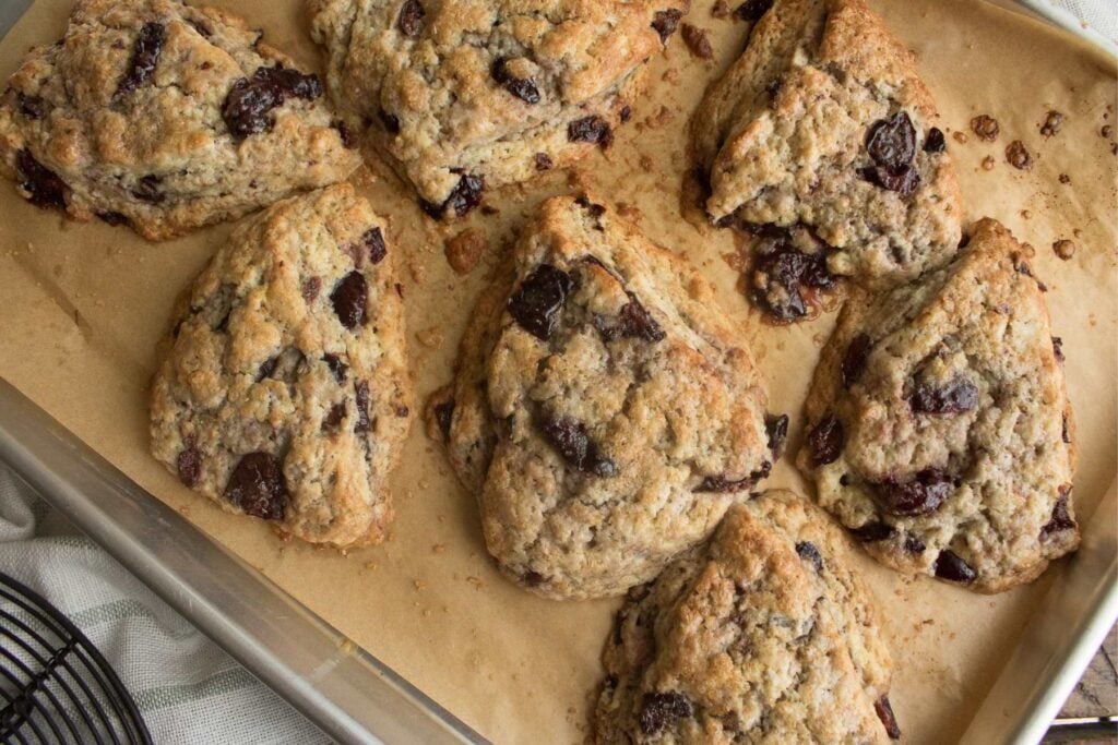 tray of freshly baked scones with cherries.