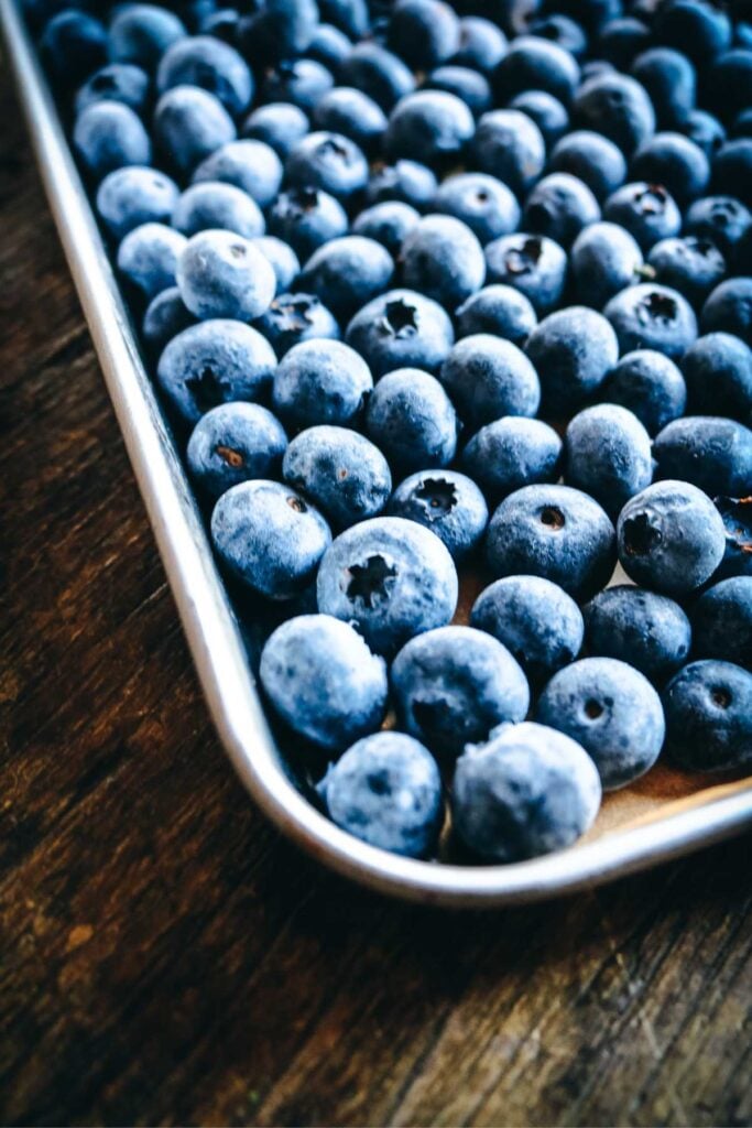 frozen blueberries on a sheet pan.