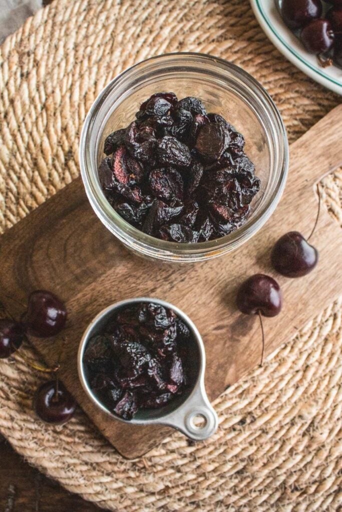 vintage measuring cup with dehydrated cherries dried in dehydrator.