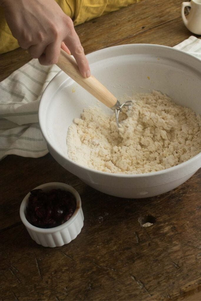 mixing scone dough in a bowl.