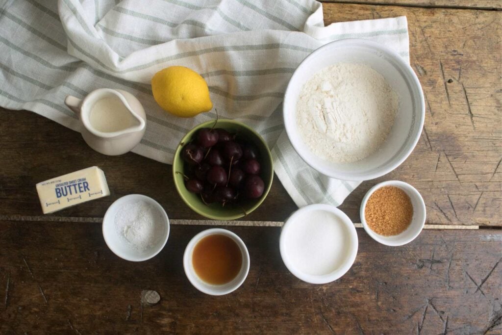 ingredients for cherry scone recipe with fresh scones and lemon zest.