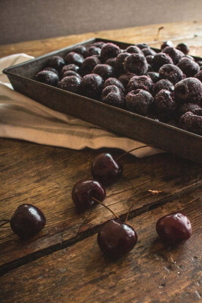 vintage baking dish full of frozen cherries.
