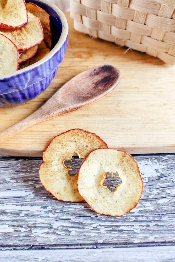 dehydrated apple slices on a wooden surface.