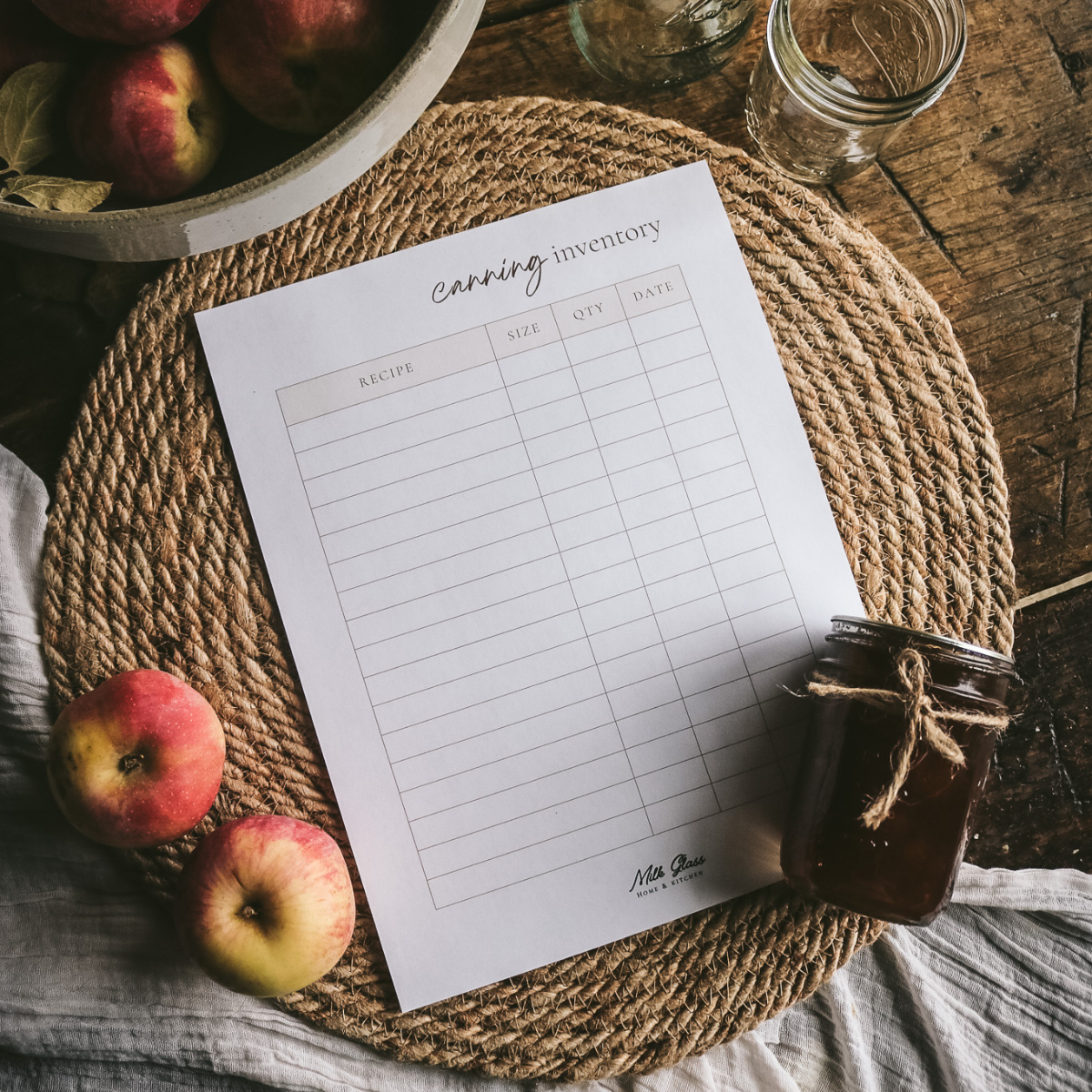printable canning inventory list next to a jar of apple butter and apples.