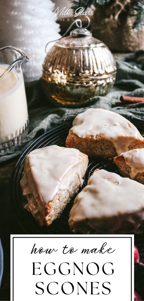 pin with a tray of eggnog scones cooling next to eggnog and a christmas ornament.