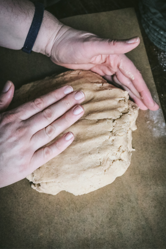 forming honey gingerbread dough into a large round.