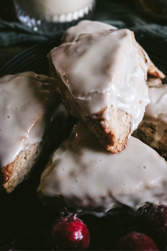 close up view of glazed eggnog scones on a tray together.