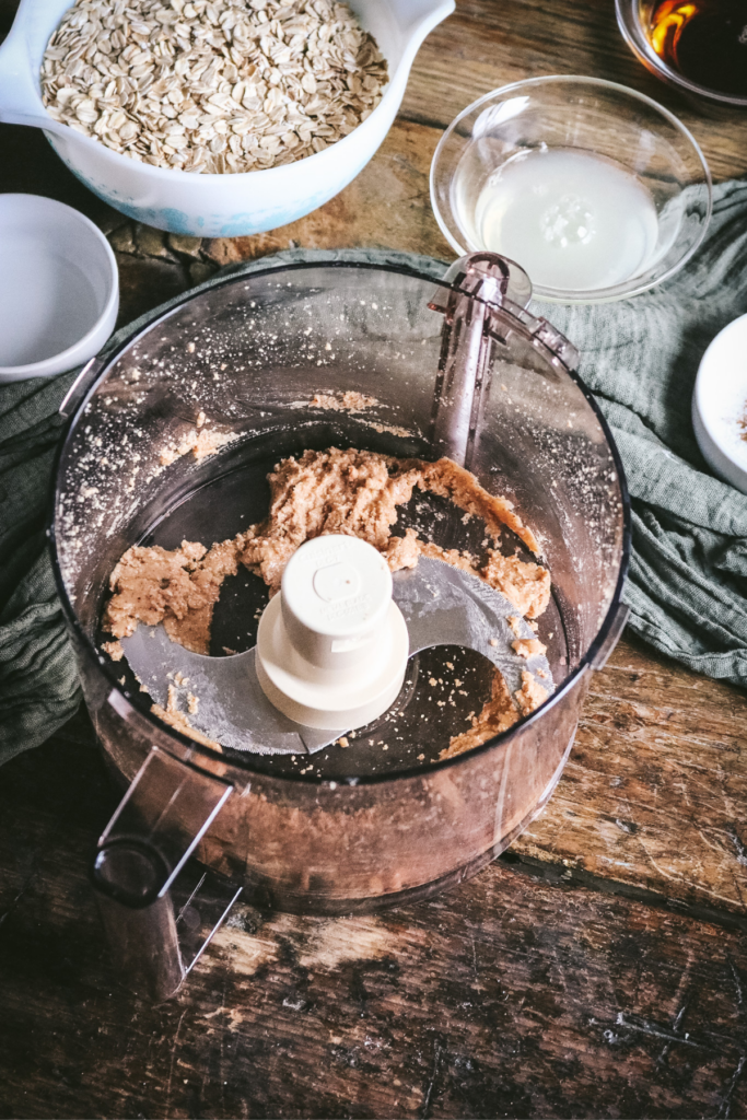 blending hazelnuts into hazelnut butter for homemade granola.