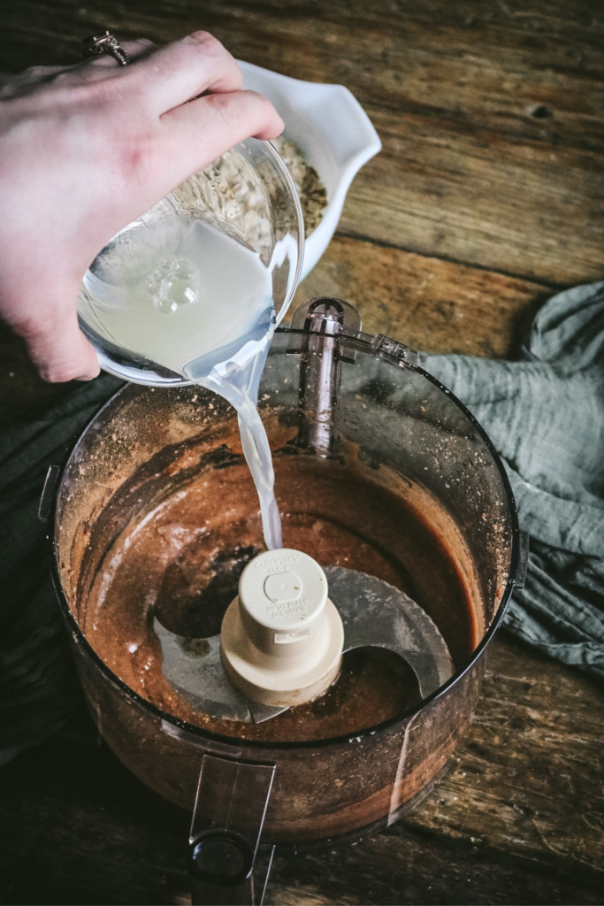 adding egg whites to food processor with maple cinnamon hazelnut butter.