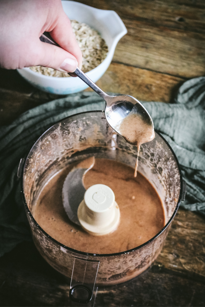 stirring hazelnut granola topping.