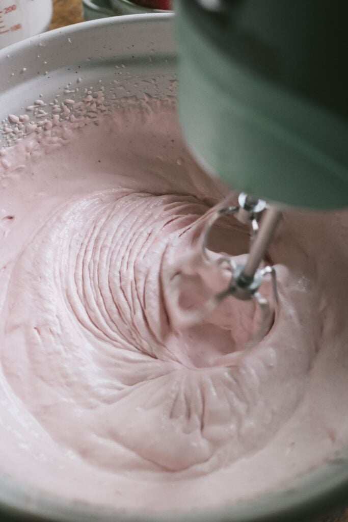 white mixing bowl with homemade strawberry whipped cream.