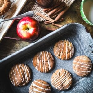 soft, chewy apple cider cookies with apple glaze in a gray graniteware baking dish.