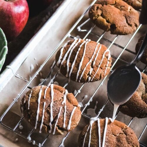 drizzling homemade apple cider glaze on apple cider crinkle cookies.