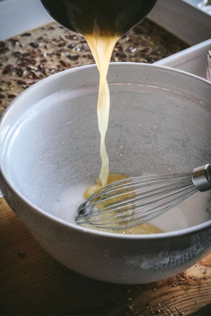 adding butter to sugar to make cobbler topping for pecan pie cobbler.