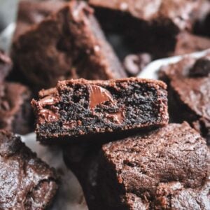 close up view of a fudgy chocolate chocolate chip cookie bar with molten chocolate chips in the middle.