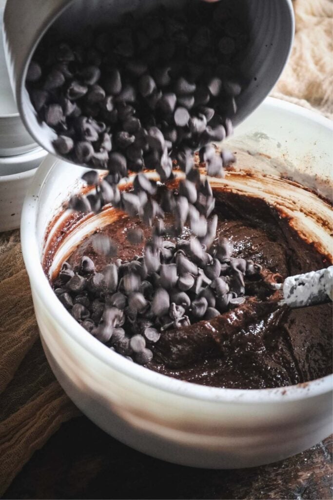 adding chocolate chips to cookie bars.