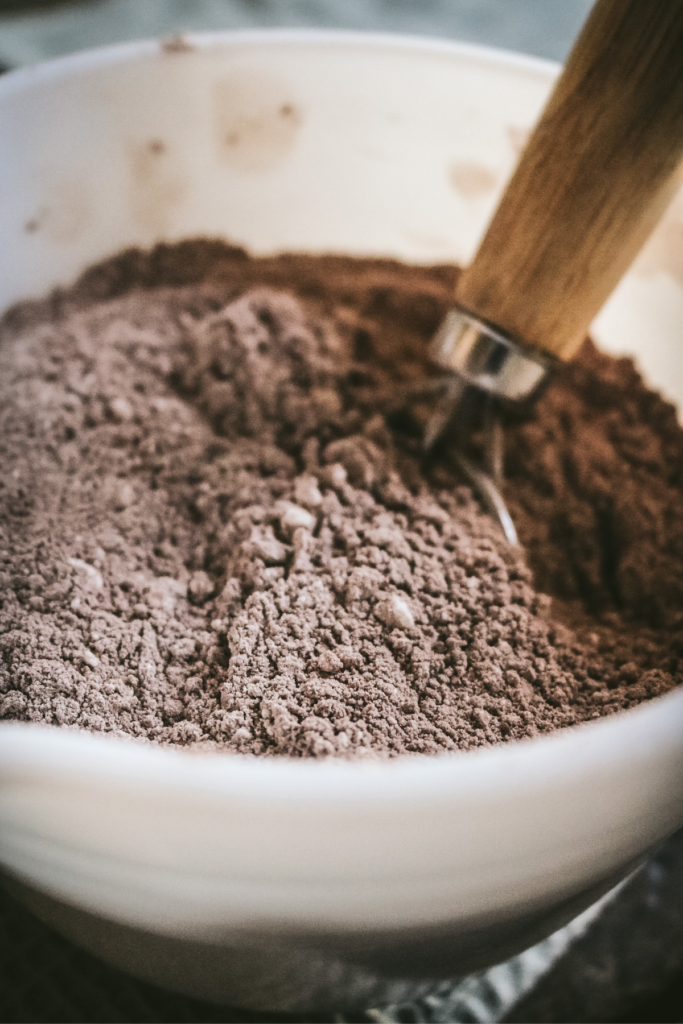 whisked hot cocoa mixture in a white bowl.