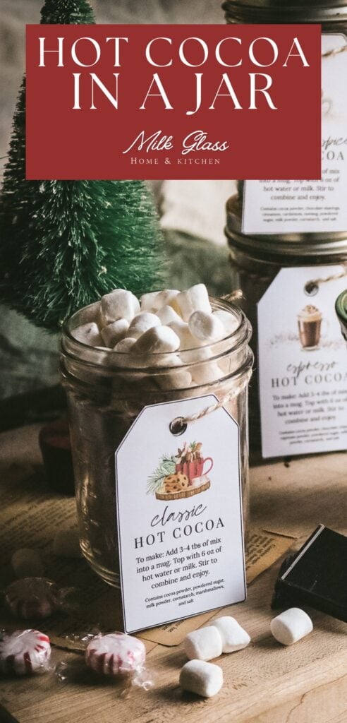 pin with an image of a mason jar holding homemade hot cocoa mix made with powdered milk, cocoa powder, powdered sugar, cornstarch, and salt with marshmallows on top.