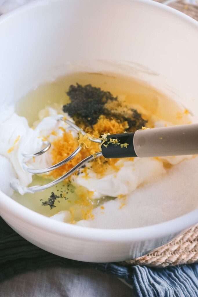 whisking the wet ingredients for lemon and poppyseed muffins together.