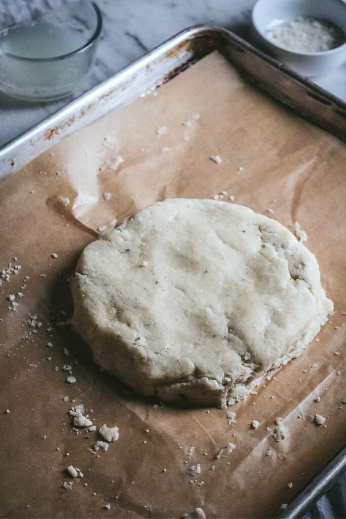 round of vanilla scone dough on a sheet pan ready to refrigerate.