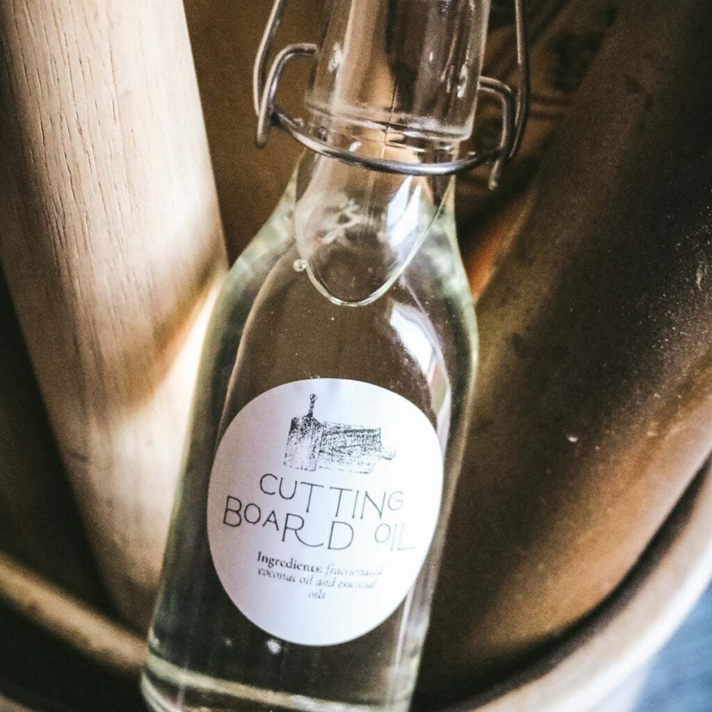 image of a glass bottle with fractionated coconut oil and essential oils and a label that reads cutting board oil.