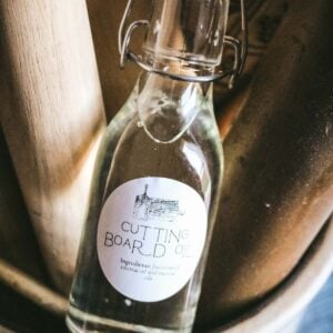 image of a glass bottle with fractionated coconut oil and essential oils and a label that reads cutting board oil.
