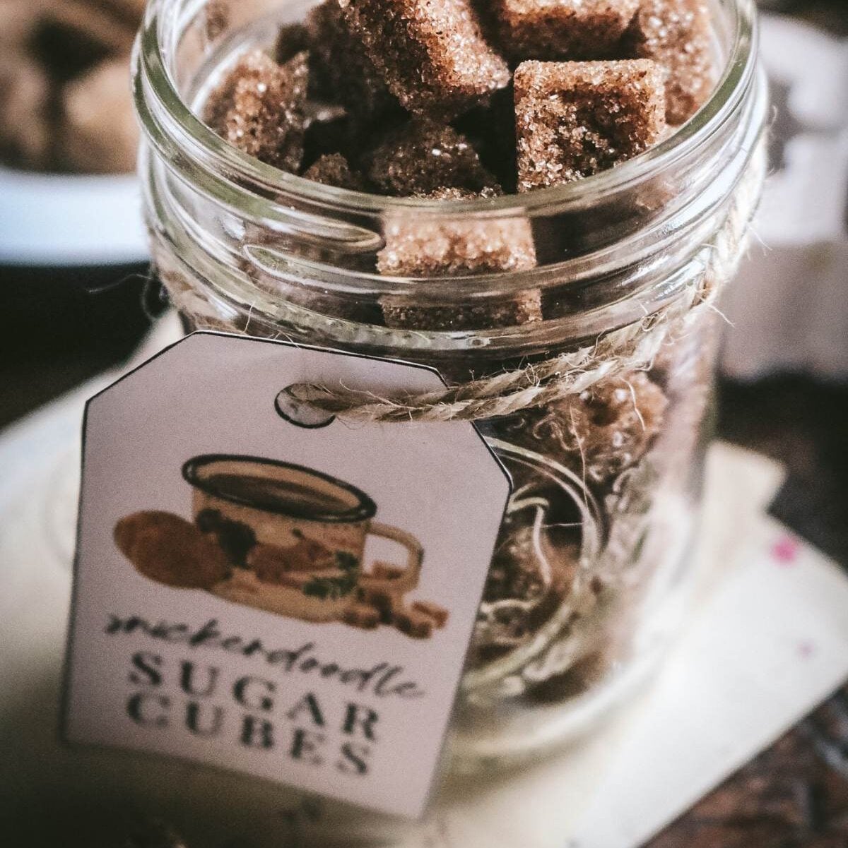 jar of homemade snickerdoodle sugar cubes with a printable gift tag.