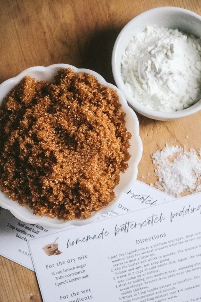 overhead view of the ingredients to make butterscotch pudding with brown sugar, salt, and cornstarch.