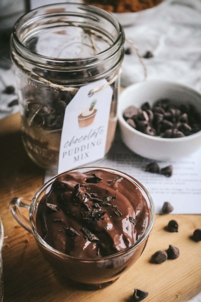 scene with homemade chocolate pudding next to a jar of the pudding mix plus printable tags.