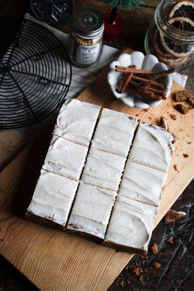 sliced gingerbread blondies with a cream cheese frosting over top.