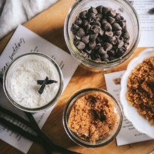 overhead view of mason jars with three types of homemade pudding mixes including vanilla bean, butterscotch, and chocolate with printable tags and labels for gifting.