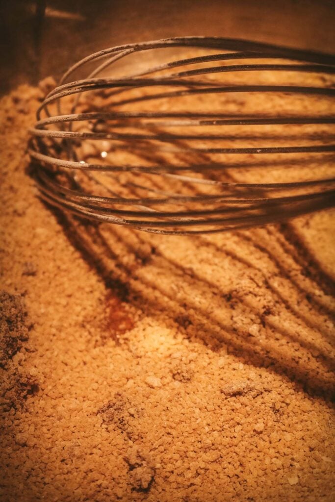 a metal saucepan with melting brown sugar to make caramelized butterscotch pudding.