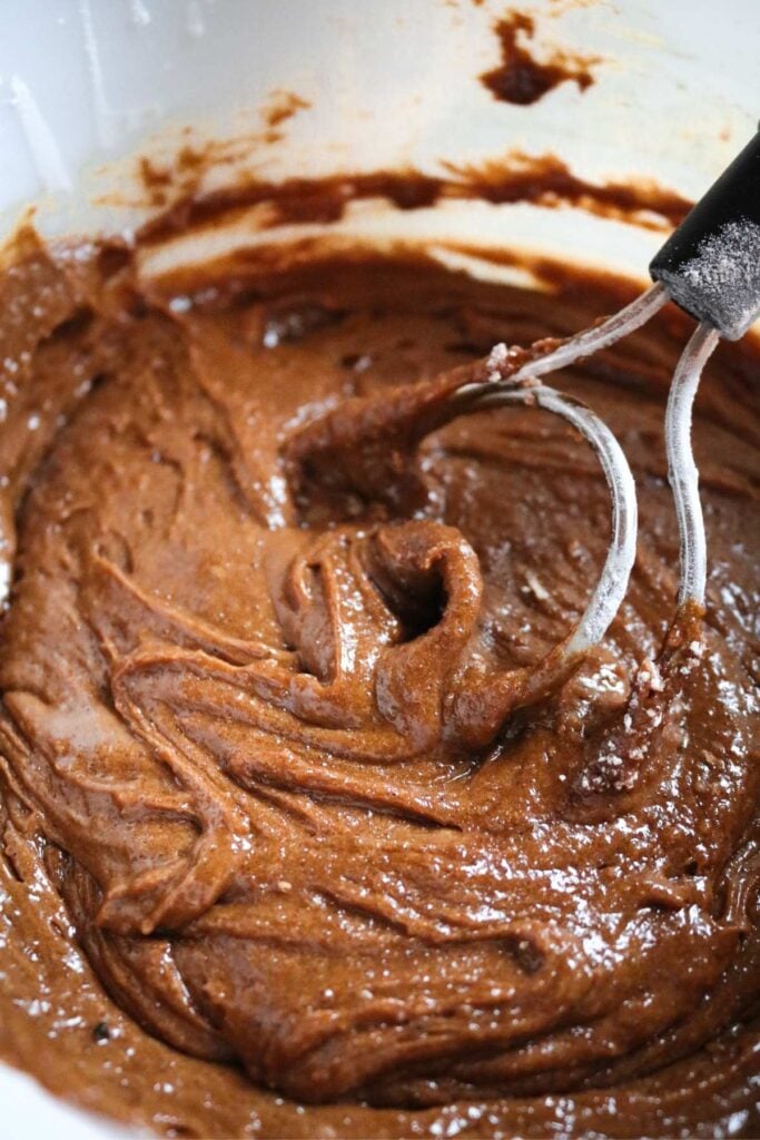 thoroughly whisked bowl of gingerbread blondie batter with a dough whisk.
