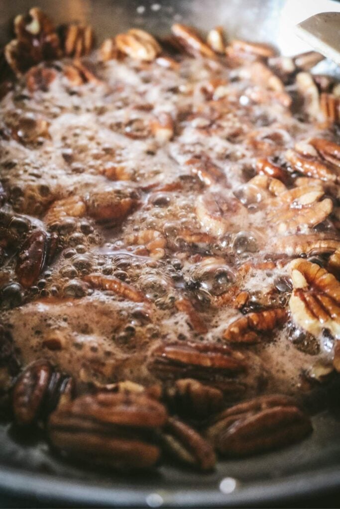 maple syrup bubbling up over the pecans to make candied pecans.