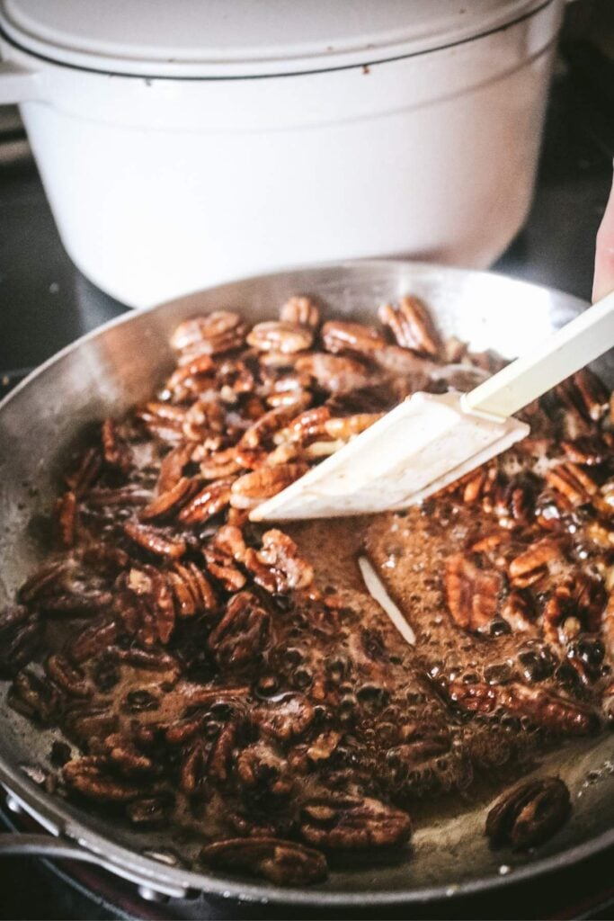 making maple pecans and testing to see how thick the maple syrup mixture is.
