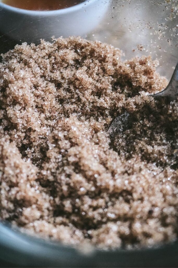 bowl full of sugar, vanilla extract, and cinnamon for flavored sugar cubes.