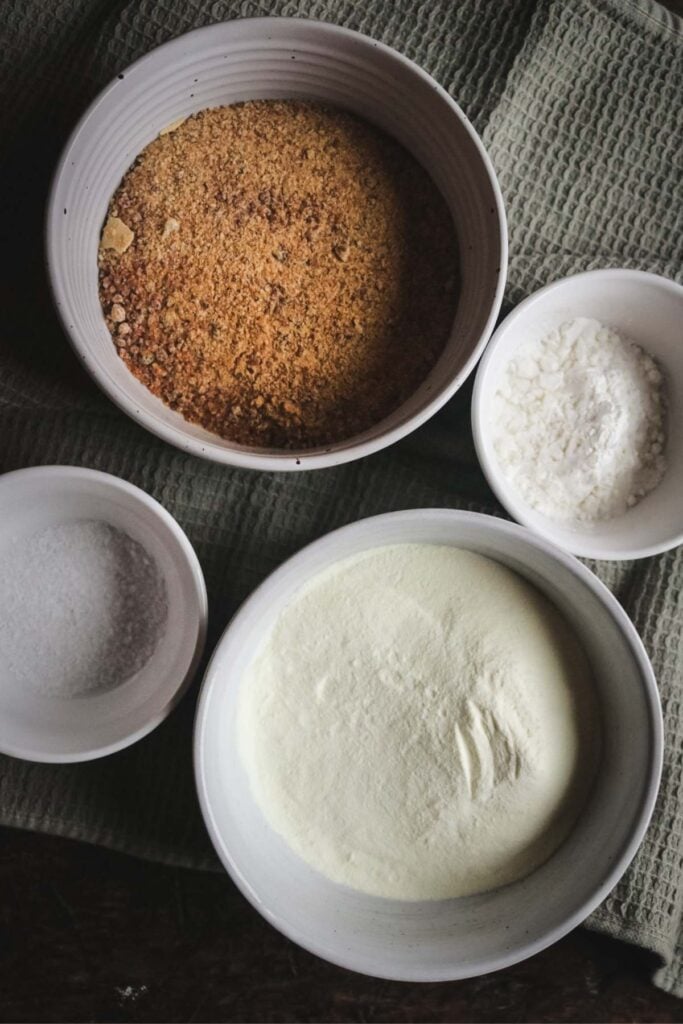 overhead view of the ingredients to make hot caramel milk including caramel sugar and milk powder.