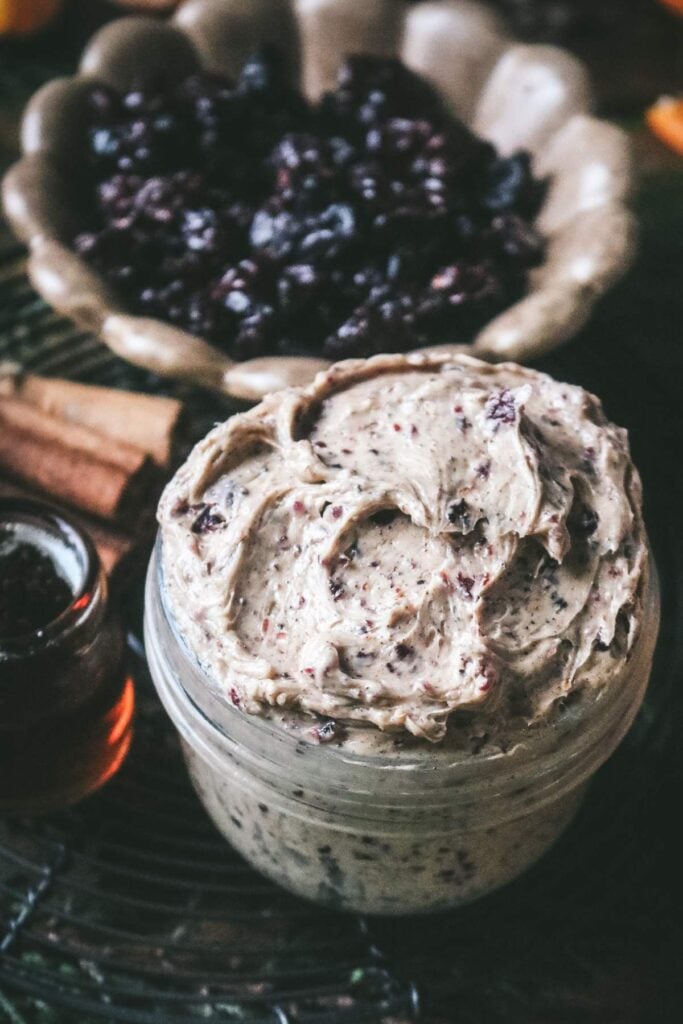 overhead view of lusciously creamy spiced cranberry butter for the holidays with maple syrup and cinnamon.