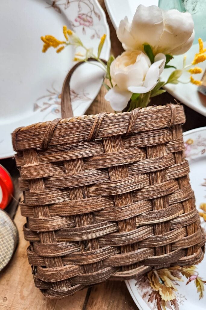 handmade wall basket in front of antique plates to demonstrate the value of slower, analog hobbies.