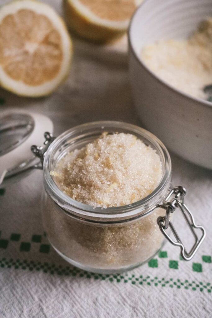 glass jar with homemade lemon infused sugar.